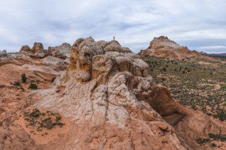 Unrecognizable person standing on a unique rock formation at White Pocket, Arizona, USA,