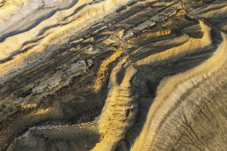Aerial view of Utah's golden sandstone desert. Dramatic patterns and textures create a mesmerizing