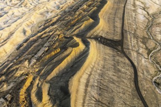Captivating aerial shot showcasing the golden hues of sandstone formations in Utah's desert. The