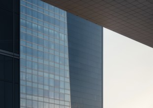 Close-up view of sleek, modern glass buildings in a downtown setting showcasing contemporary
