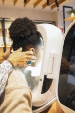 A technician assists a customer engaging with advanced skin analysis technology in a cosmetics