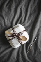 Top view of an elegantly presented bento birthday cake, securely packaged in a white takeout box