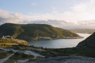 A serene view of Signal Hill, St. John's showcasing a sweeping coastline with a sunlit harbor