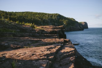 A serene view of the rugged cliffs descending into the ocean at Flatrock, Newfoundland & Labrador,