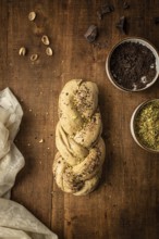 Top view of a freshly baked Bakbah bread adorned with chocolate shavings and pistachio bits, placed