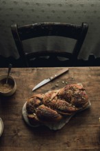 Top view of a freshly baked chocolate and pistachio babka bread, placed on a rustic wooden table