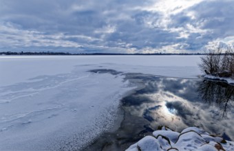 View of Schaalsee, covered with ice and snow, on the bridge tour, a hiking trail around Lake