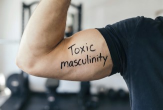 Muscular man flexing bicep with text toxic masculinity highlighting harmful male stereotypes.