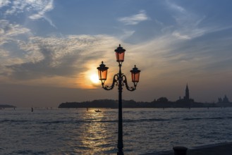 View of Giudecca Island in the evening, historic lantern in front, Venice, Veneto, Italy