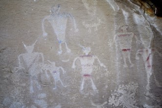 Historical art with human figures, petroglyphs from the Fremont culture, drawn on a rock wall,