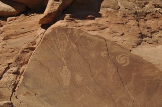 Elaborate petroglyphs from the Fremont culture on a reddish sandstone, Dinosaur National Monument,