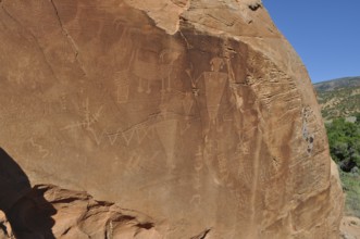 Petroglyphs of the Fremont culture on a large sandstone with ancient engravings, Dinosaur National