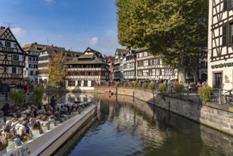 Sightseeing boat, half-timbered houses and the Maison des Tanneurs on the river Ill in Petite