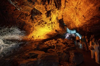 Underground cave formed by lava flow, visitors illuminated lava cave, Cueva de los Verdes,