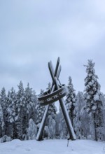 Monument on polar ice, snowy forest, Lapland, Finland