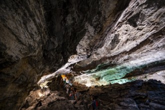 Underground cave formed by lava flow, visitors in illuminated lava cave, Cueva de los Verdes,