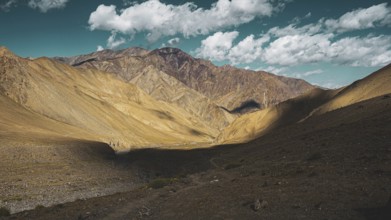 Barren mountain landscape with shade and blue sky, trekking in Ladakh, Stok la, Himalayas, India