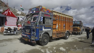 Colourful Indian truck parked at Khardung-La Pass, trekking in Ladakh, Stok la, Himalayas, India