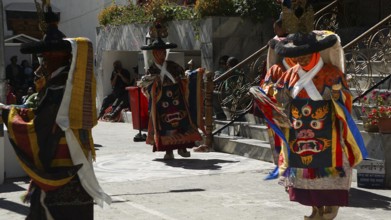 People in traditional costumes dance outside at a cultural event in Leh, trekking in Ladakh,