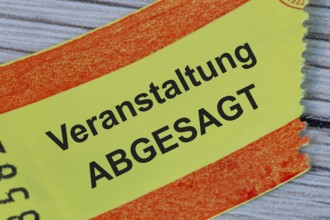 (photo montage) Ticket with text EVENT CANCELLED