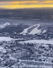 View of the snowy town of Rovaniemi with the Kemijoki river, at sunrise, in winter, aerial view,