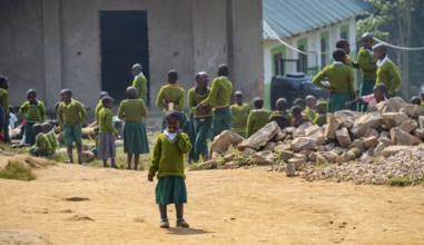 Schoolchildren in school uniform in the schoolyard during recess, Rushaga, Western Region, Uganda