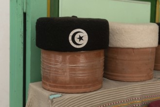 A black with crescent and star motif Tunisian Chechia, traditional soft wool hats popular in the