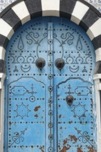 Detailed design of a traditional blue door in the Tunisian cliff top village of Sidi Bou Said,