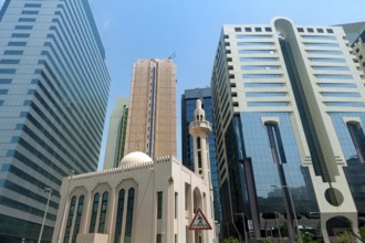 Abu Dhabi, United Arab Emirates. June 23rd 2019 A mosque among modern glass fronted office