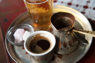 Traditional Bosnian Coffee served from a copper pot with local sweets. Sarajevo, Bosnia and
