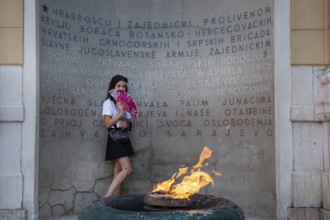 Sarajevo, Bosnia and Herzegovina. July 24th 2019. A young girl poses in front of The Eternal flame