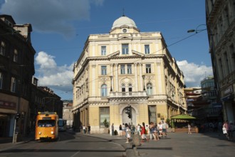 A tram passing in the street beside The Eternal flame, a memorial to the military and civilian