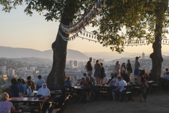 Sarajevo, Bosnia. July 25th 2019 Tourists watch the sunset from the terrace of the Park Princeva