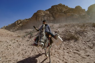 Petra, Jordan. December 12th 2012 A Jordanian Bedouin boy riding a donkey, Petra, Jordan