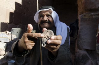 Petra, Jordan. December 13th 2012 Jordanian Bedouin selling artifacts to tourists Petra Jordan