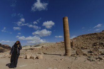 Petra, Jordan. December 11th 2012 A Jordanian Bedouin woman near a monument known as the Pharaohs