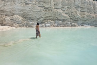 Pamakkule, Turkey, April 25th 2020 A tourist soak her feet in the thermal waters of the Travertine