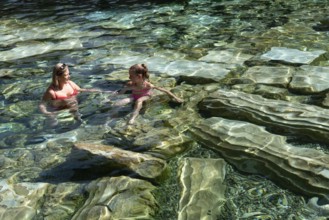 Pamakkale, Turkey, April 25th 2020 A woman and child enjoy the healing properties of thermal waters