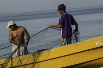 Barka, Oman. May 30th 2014 Omani fishermen with their nets beside the sea near Barka, Oman