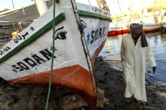 Aswan Egypt. January 12th 2013 Nubian Felucca captain with his sail boat on Elephantine Island