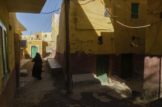 Aswan, Egypt. 10th January 2013 A local Muslim women walking in the narrow alleyways of a Nubian