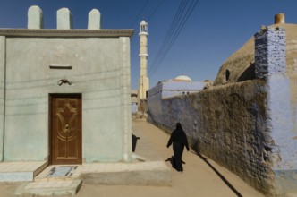Aswan, Egypt. 11th January 2013 A Muslim woman walking towards a mosque in a Nubian Village on the
