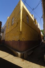 Aswan, Egypt. 8th January 2013 The bright yellow corner of a traditional house, a Nubian Village on