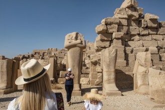 Luxor, Egypt. December 12th 2022 Tourists posing for selfie photographs beside Egyptian statues at