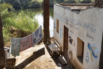 Luxor, Egypt. 13th December 2020 Typical Nile side house with painted Haj pilgrimage murals in a