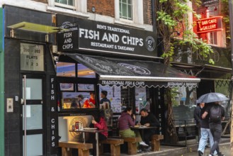 London, United Kingdom. August 2nd 2023 Traditional British Fish and Chip Shop in the rain, famous