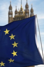 European flag with the British Houses of Parliament, the seat of the UK government in Westminster,