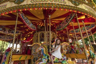 London, United Kingdom, June 28th 2022 Child enjoying funfair carousel ride at the South Bank, near