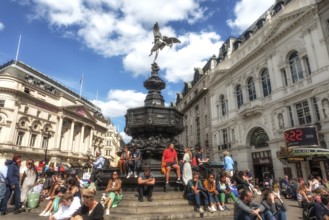 London, United Kingdom, June 28th 2022 Tourists sitting on the steps of the Shaftesbury Memorial