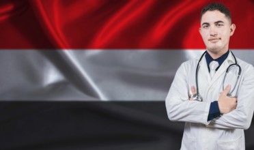 Portrait of medical professional on Yemen flag background. Yemeni national health system